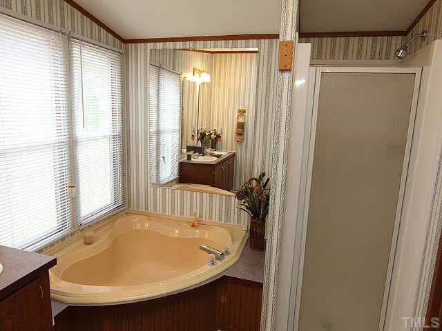 4501 Durham Road Raleigh, NC 27614 - Photo 9 of 12 a view of a bedroom with a bed and wooden floor