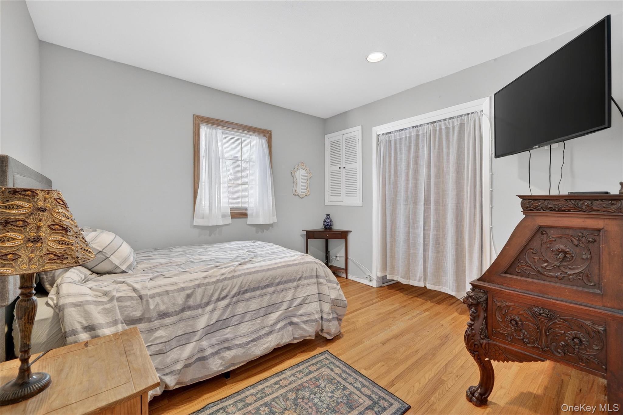 5 Raleigh Drive New City, NY 10956 - Photo 25 of 44 a bedroom with a bed a flat screen tv and a couch