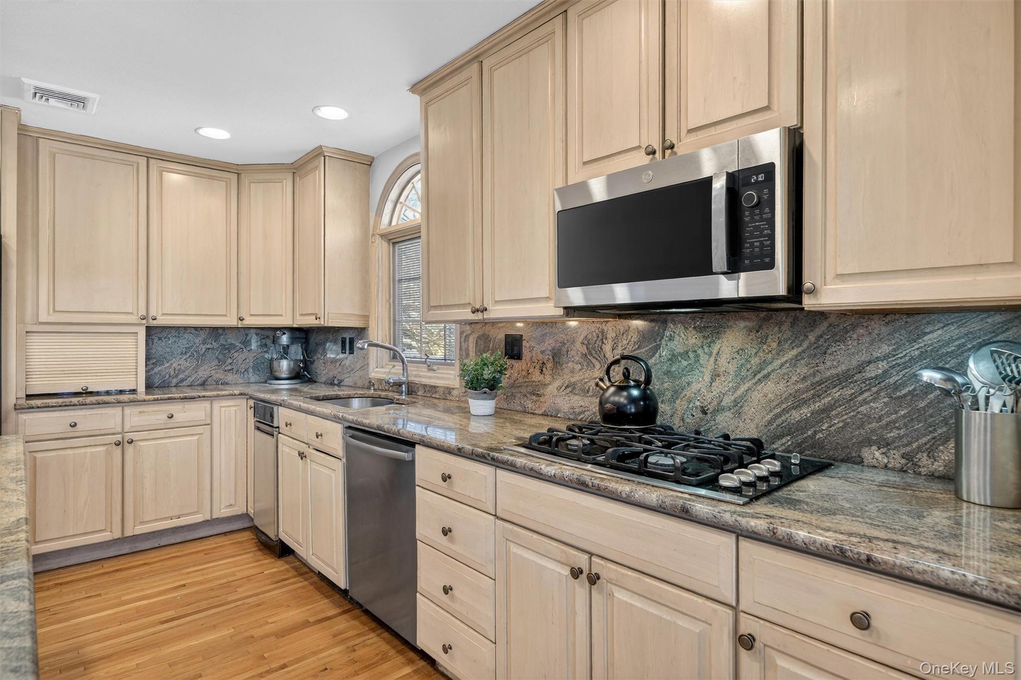 5 Raleigh Drive New City, NY 10956 - Photo 9 of 44 a kitchen with stainless steel appliances granite countertop white cabinets granite counter tops and a wooden floors