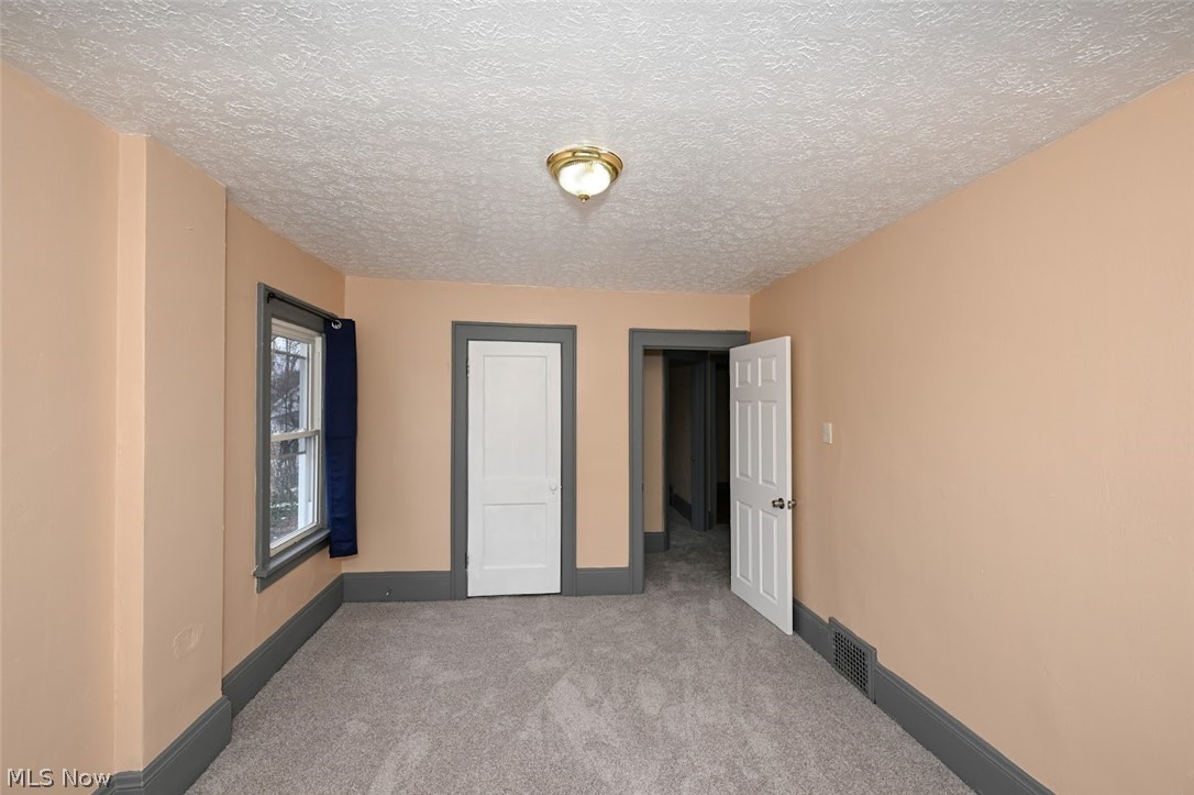 77 West Mildred Avenue Akron, OH 44310 - Photo 28 of 40 Unfurnished bedroom with carpet floors and a textured ceiling