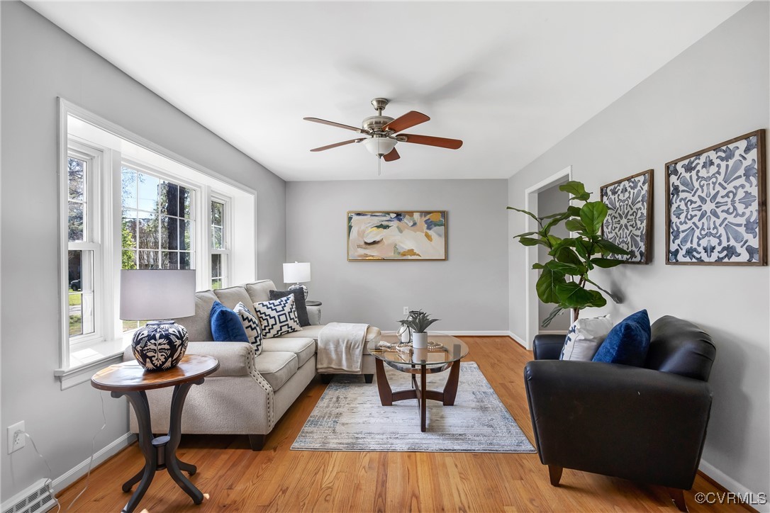 Living room with baseboards, wood finished floors,