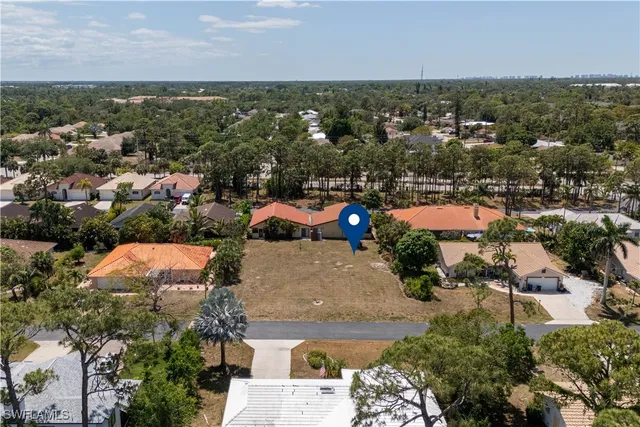 an aerial view of a house with a swimming pool yard and outdoor seating