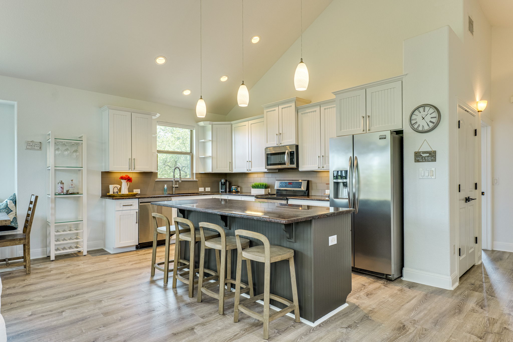 433 Venture Boulevard South Point Venture, TX 78645 - Photo 10 of 36 This kitchen was made for pre-deck gathering, with a large island, bar seating, and plenty of room for people to naturally land.