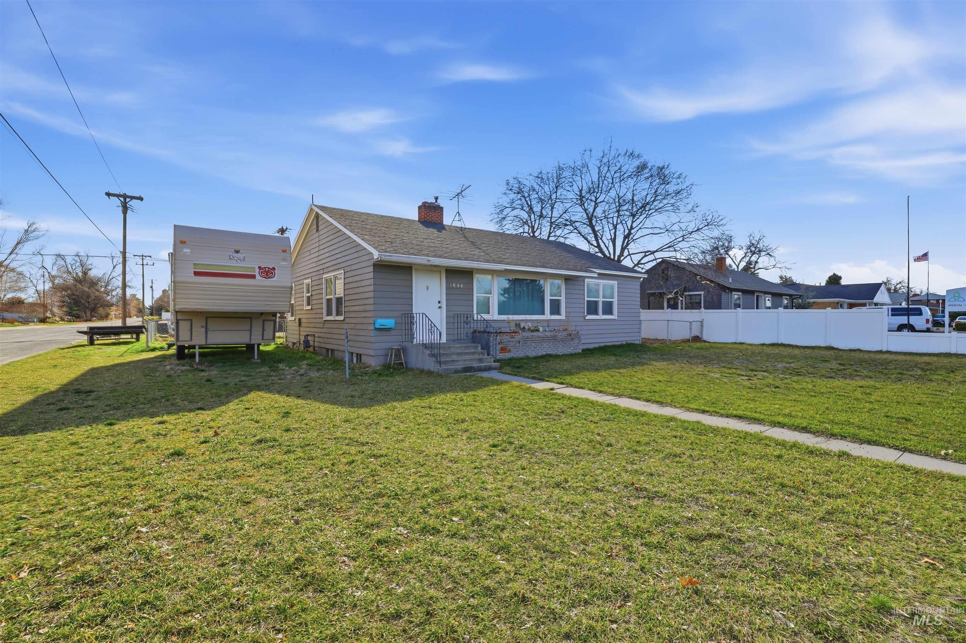 1644 Addison Avenue East Twin Falls, ID 83301 - Photo 3 of 18 View of front facade featuring a chimney and roof with shingles
