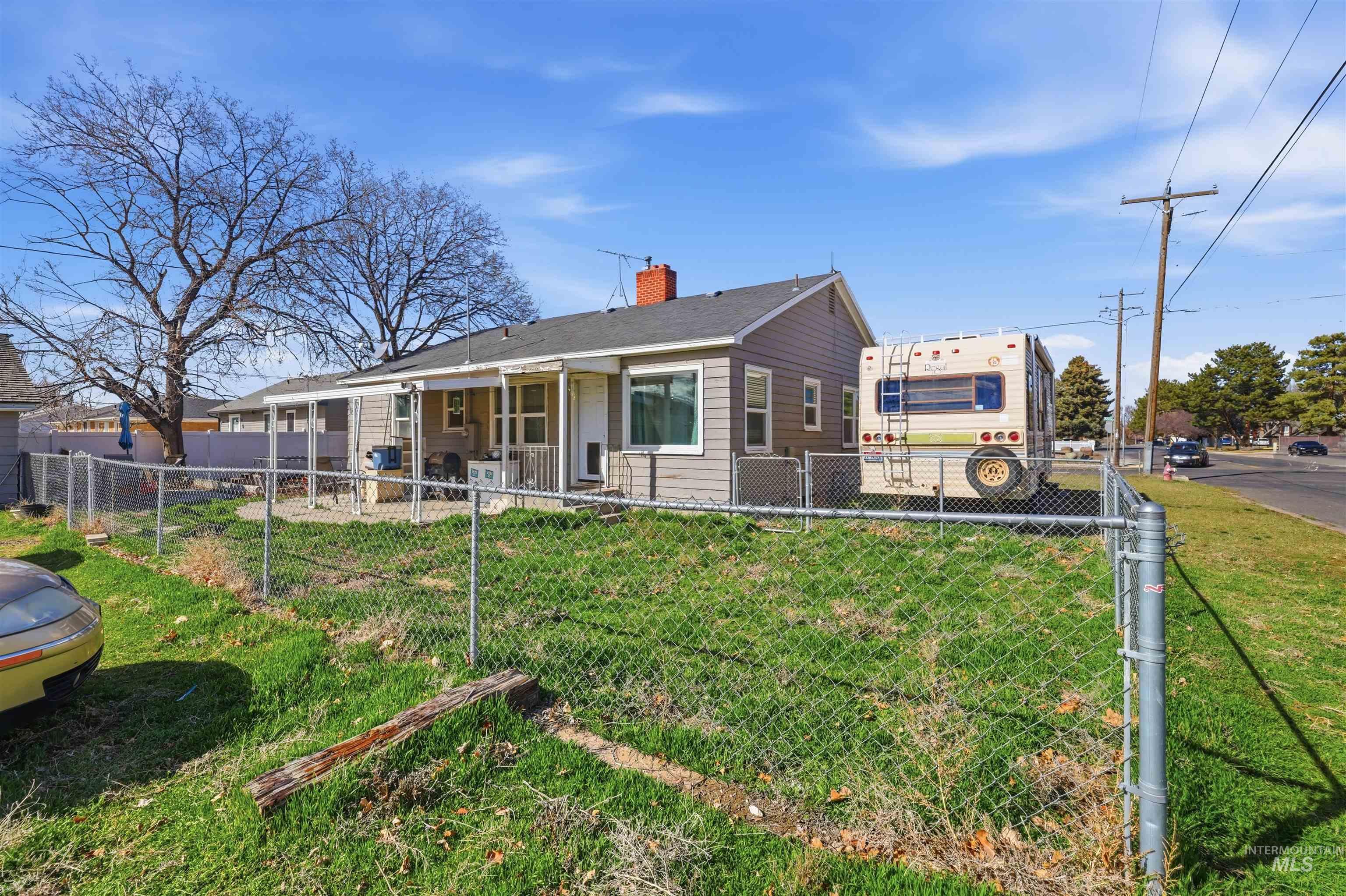1644 Addison Avenue East Twin Falls, ID 83301 - Photo 4 of 18 Bungalow featuring a chimney, a fenced backyard, and a patio