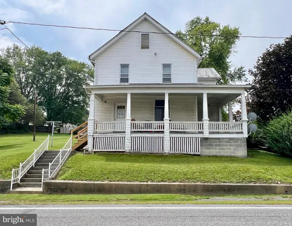 a front view of a house with a yard table and chairs