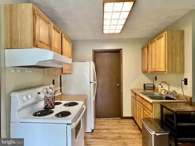 a kitchen with a stove and a refrigerator