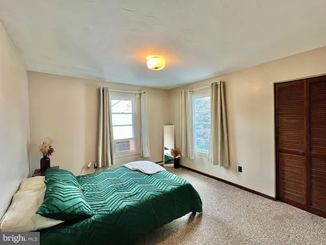 a spacious bedroom with a bed and a window