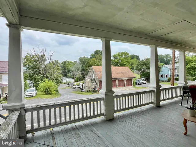 a view of a porch with wooden floor in outdoor space