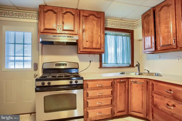 a kitchen with stainless steel appliances granite countertop a stove and a cabinets