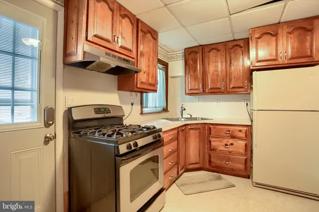 a kitchen with stainless steel appliances granite countertop a stove a refrigerator and a refrigerator