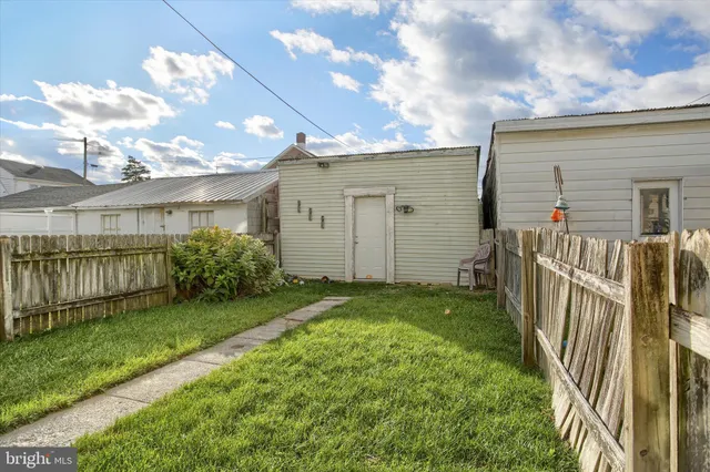 a front view of a house with a yard table and chairs