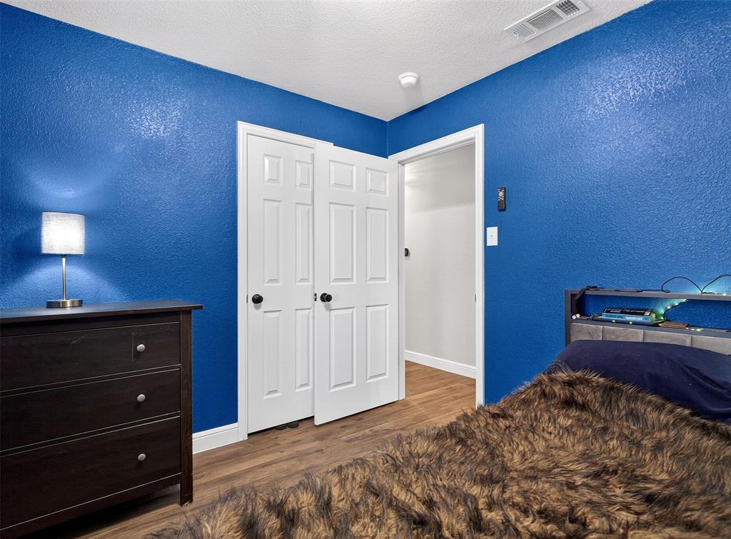 1006 Oakchase Court Azle, TX 76020 - Photo 10 of 19 a bedroom with a bed and a dresser
