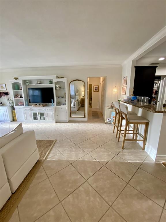 2755 Northeast 28th Avenue, Unit E3 Lighthouse Point, FL 33064 - Photo 2 of 48 a living room with furniture and a flat screen tv