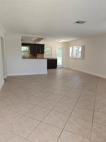 a large kitchen with stainless steel appliances granite countertop a large counter top and a stove top oven