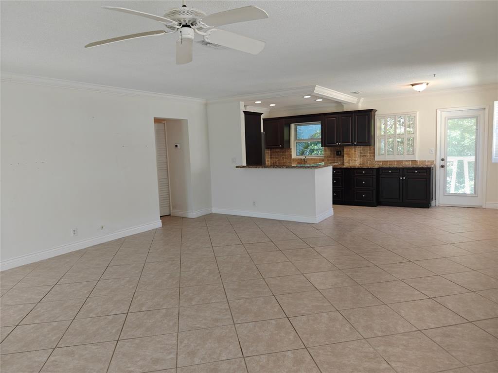 2755 Northeast 28th Avenue, Unit E3 Lighthouse Point, FL 33064 - Photo 23 of 48 a view of a living room a ceiling fan and windows