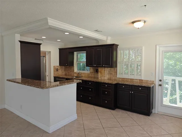a stove top oven sitting inside of a kitchen
