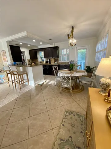 a living room with lots of furniture and kitchen view