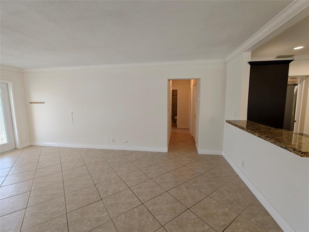 2755 Northeast 28th Avenue, Unit E3 Lighthouse Point, FL 33064 - Photo 31 of 48 a view of a livingroom with an empty space and a window