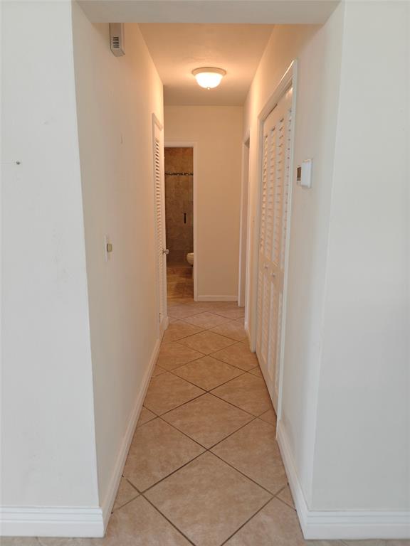 2755 Northeast 28th Avenue, Unit E3 Lighthouse Point, FL 33064 - Photo 32 of 48 a view of a hallway with a door