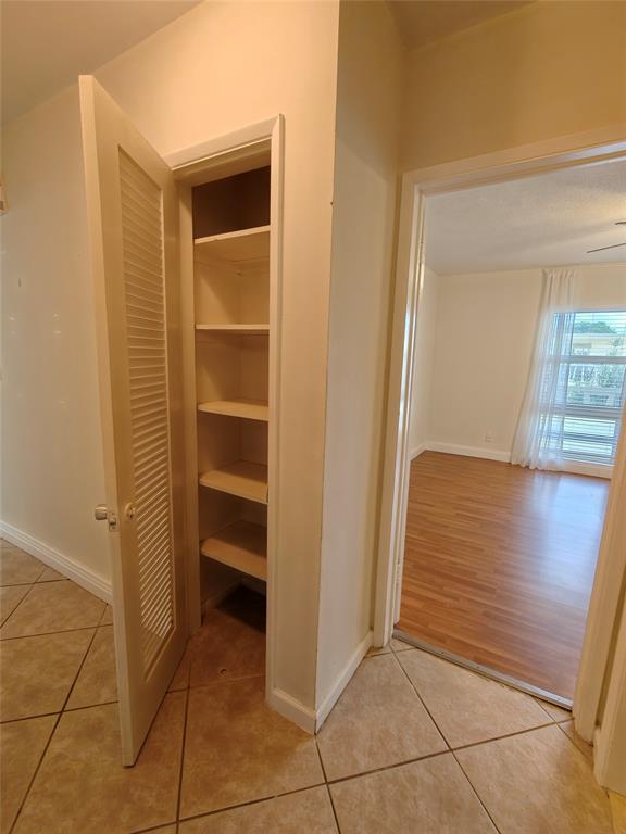 2755 Northeast 28th Avenue, Unit E3 Lighthouse Point, FL 33064 - Photo 33 of 48 a view of walk in closet with empty racks