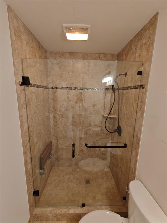 2755 Northeast 28th Avenue, Unit E3 Lighthouse Point, FL 33064 - Photo 35 of 48 a bathroom with a shower and toilet