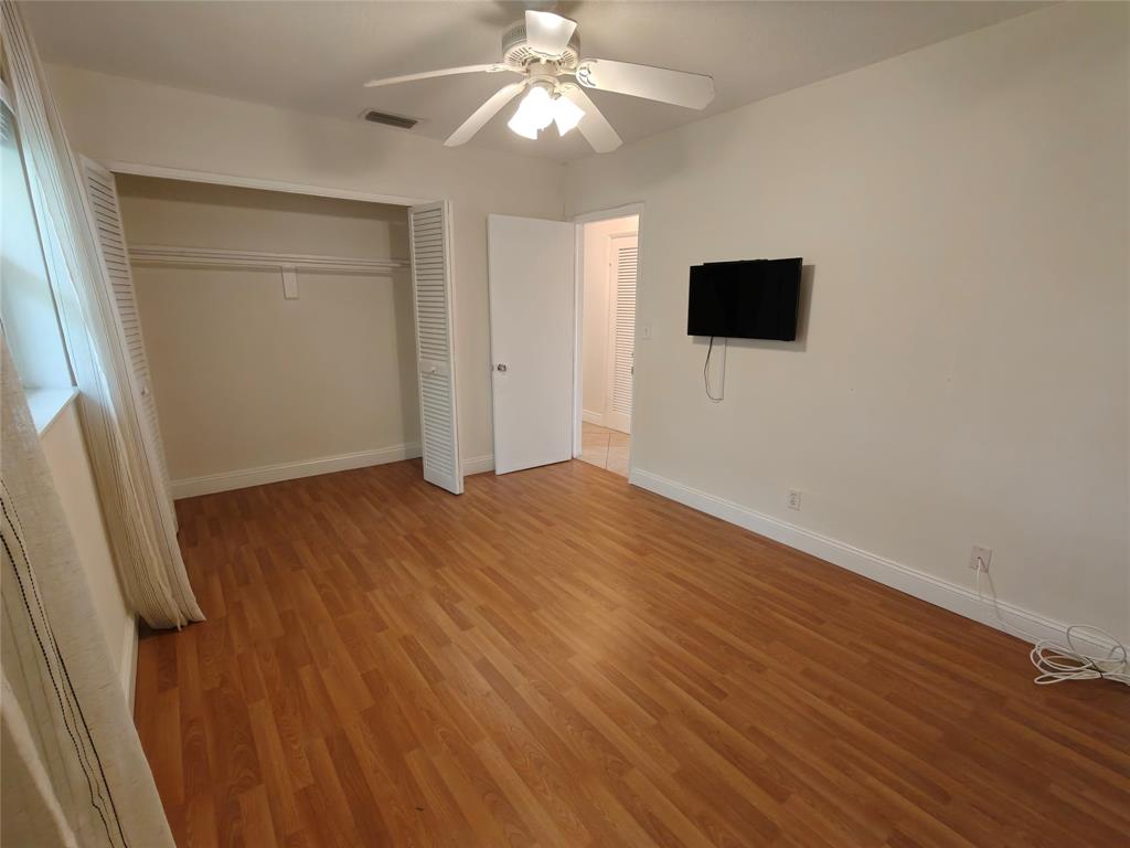 2755 Northeast 28th Avenue, Unit E3 Lighthouse Point, FL 33064 - Photo 38 of 48 wooden floor in an empty room with a window