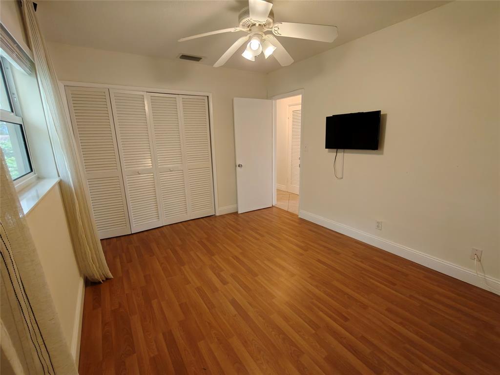 2755 Northeast 28th Avenue, Unit E3 Lighthouse Point, FL 33064 - Photo 40 of 48 a view of a livingroom with a flat screen tv
