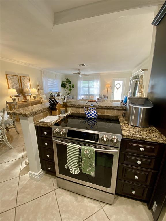2755 Northeast 28th Avenue, Unit E3 Lighthouse Point, FL 33064 - Photo 6 of 48 a kitchen with a stove and a sink
