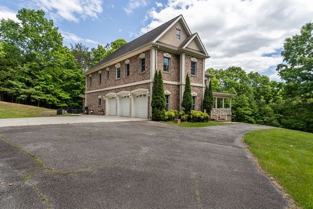 1190 Maple Grove Road Morganton, GA 30560 - Photo 16 of 96 a view of a big house with a big yard and large tree