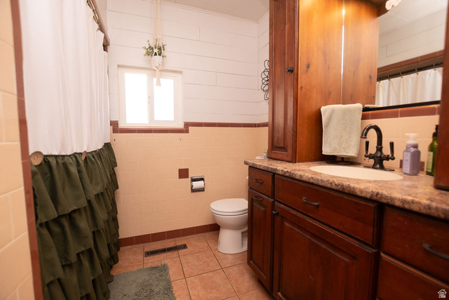 340 West 100 N Street Beaver, UT 84713 - Photo 22 of 37 Bathroom with a shower with curtain, vanity, tile walls, and light tile patterned flooring