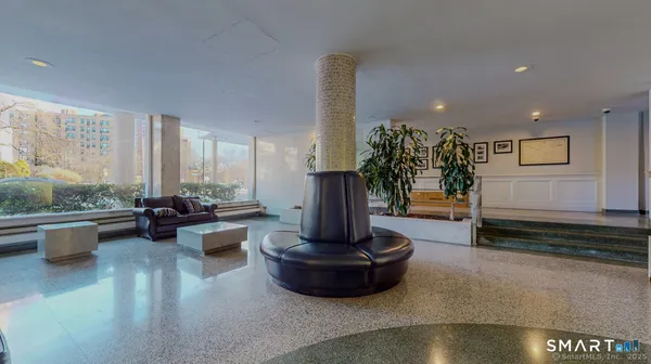 a living room with furniture and a fountain