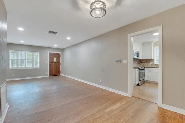 a kitchen with appliances a refrigerator and cabinets