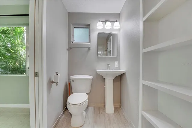 a view of a livingroom with a ceiling fan and a large window