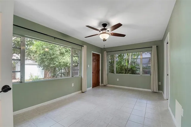 a view of a big room with windows and entryway