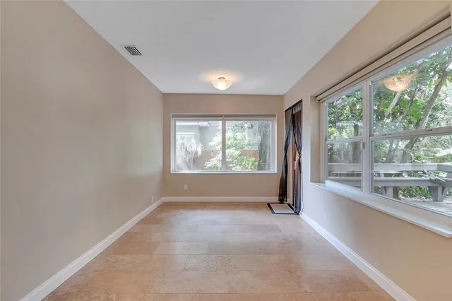 a view of a deck with chairs and wooden floor