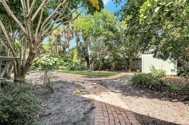 an aerial view of a house with a yard and garden
