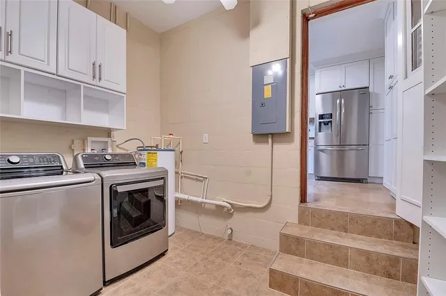 an aerial view of residential house with outdoor space and trees all around
