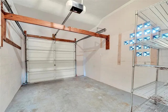 an aerial view of residential house with outdoor space and trees all around