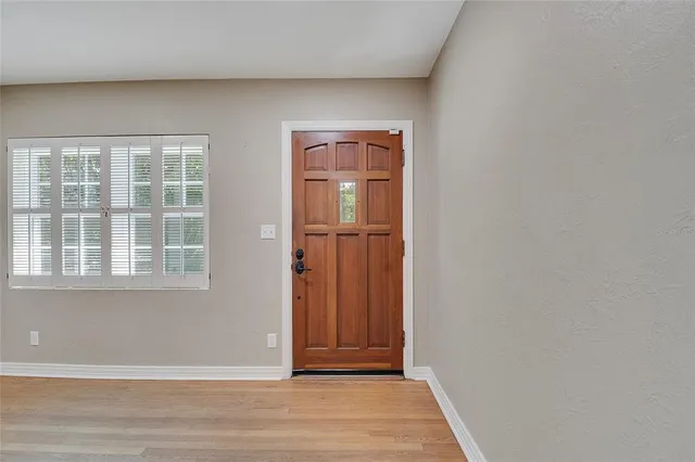 a view of hallway with wooden floor