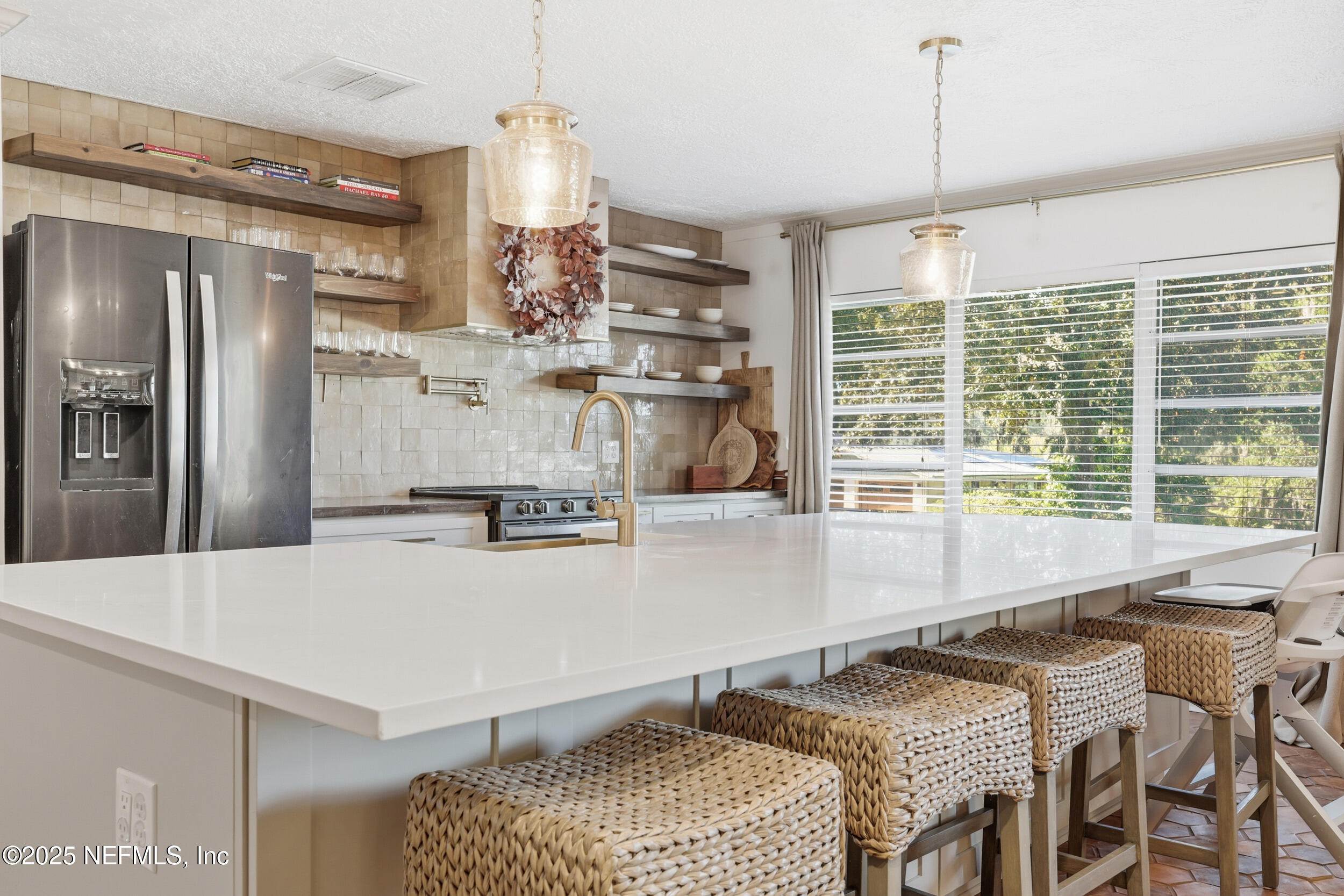 a kitchen with a table chairs and refrigerator