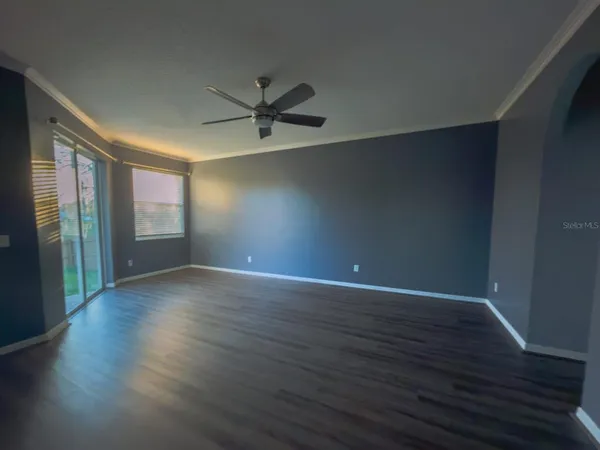 a view of wooden floor and windows in a room