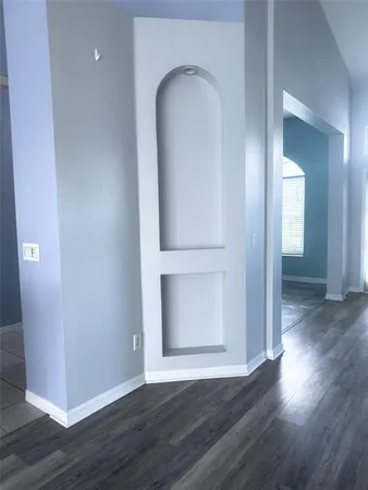 a view of a livingroom with a hardwood floor and a ceiling fan
