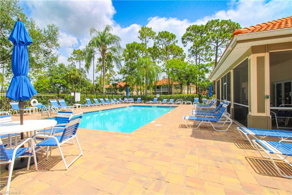 225 Robin Hood Circle, Unit 203 Naples, FL 34104 - Photo 48 of 50 View of pool with a patio