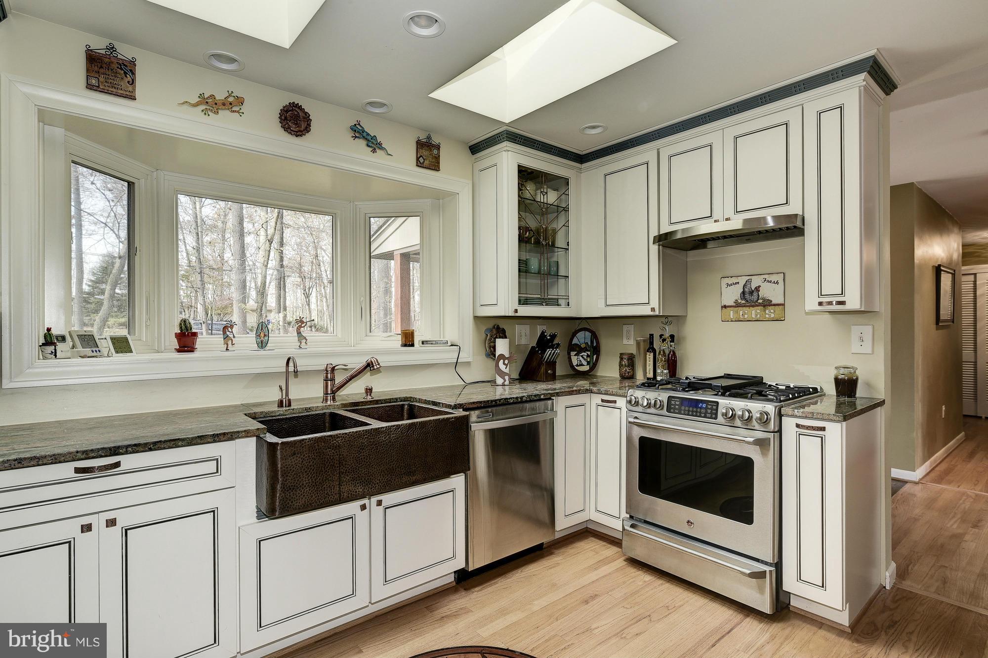 10302 Lloyd Road Potomac, MD 20854 - Photo 1 of 30 a kitchen with a sink stove and cabinets