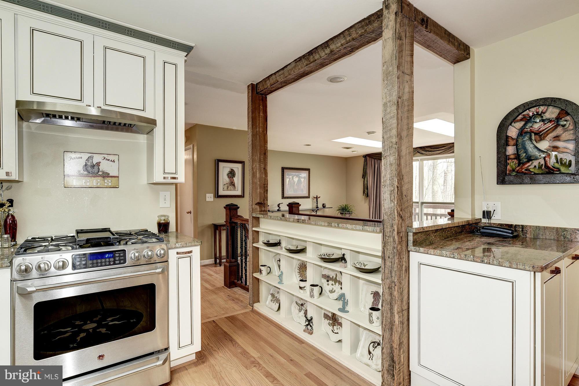 10302 Lloyd Road Potomac, MD 20854 - Photo 11 of 30 a kitchen with stainless steel appliances granite countertop a stove a sink and a refrigerator
