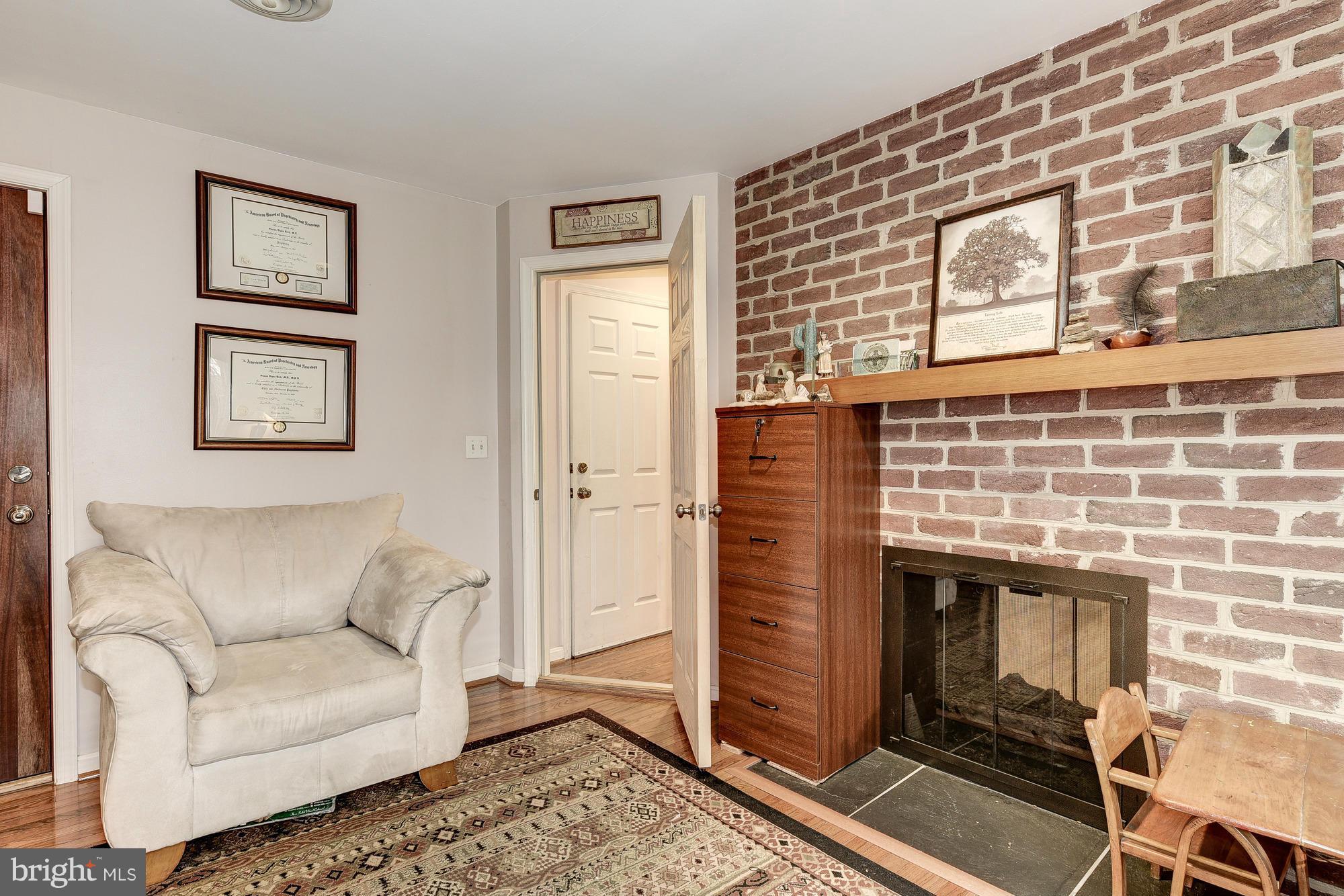 10302 Lloyd Road Potomac, MD 20854 - Photo 14 of 30 a living room with furniture and a fireplace