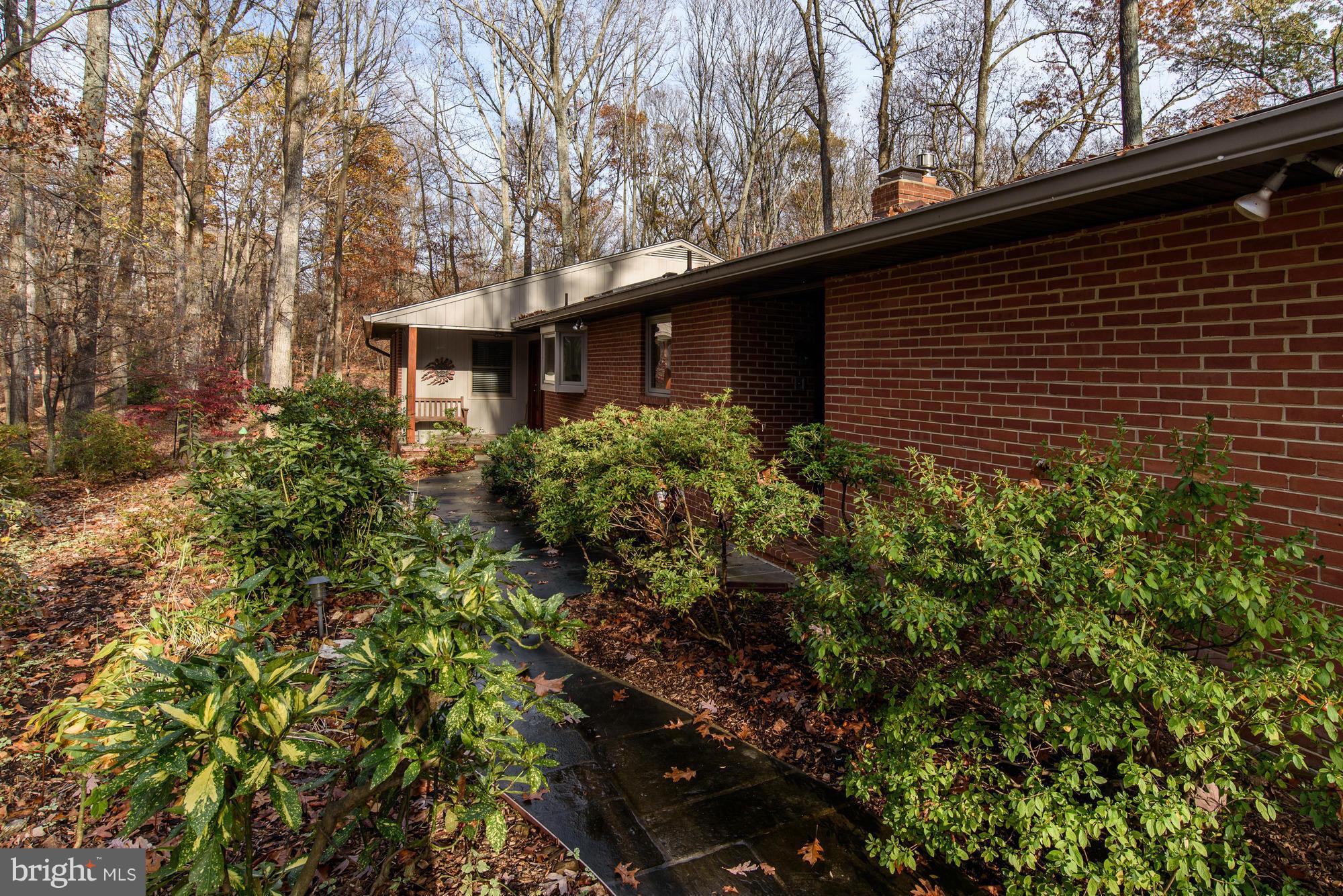10302 Lloyd Road Potomac, MD 20854 - Photo 3 of 30 a backyard of a house with lots of green space