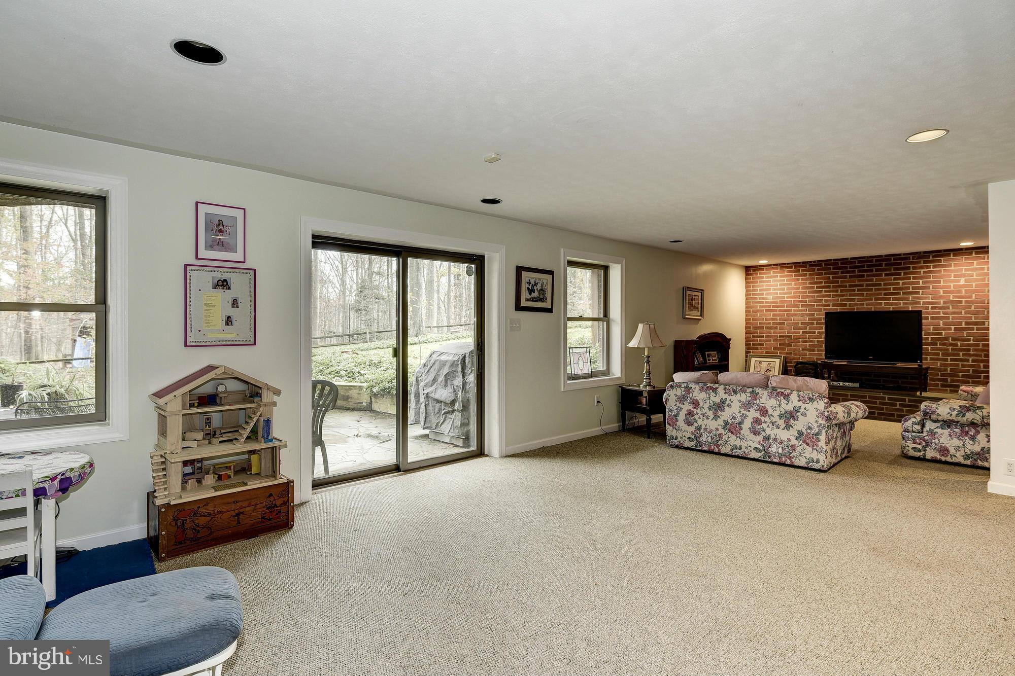10302 Lloyd Road Potomac, MD 20854 - Photo 23 of 30 a living room with furniture and a flat screen tv
