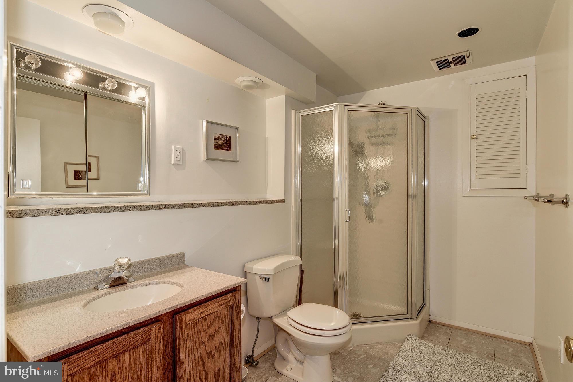 10302 Lloyd Road Potomac, MD 20854 - Photo 25 of 30 a bathroom with a sink and a mirror
